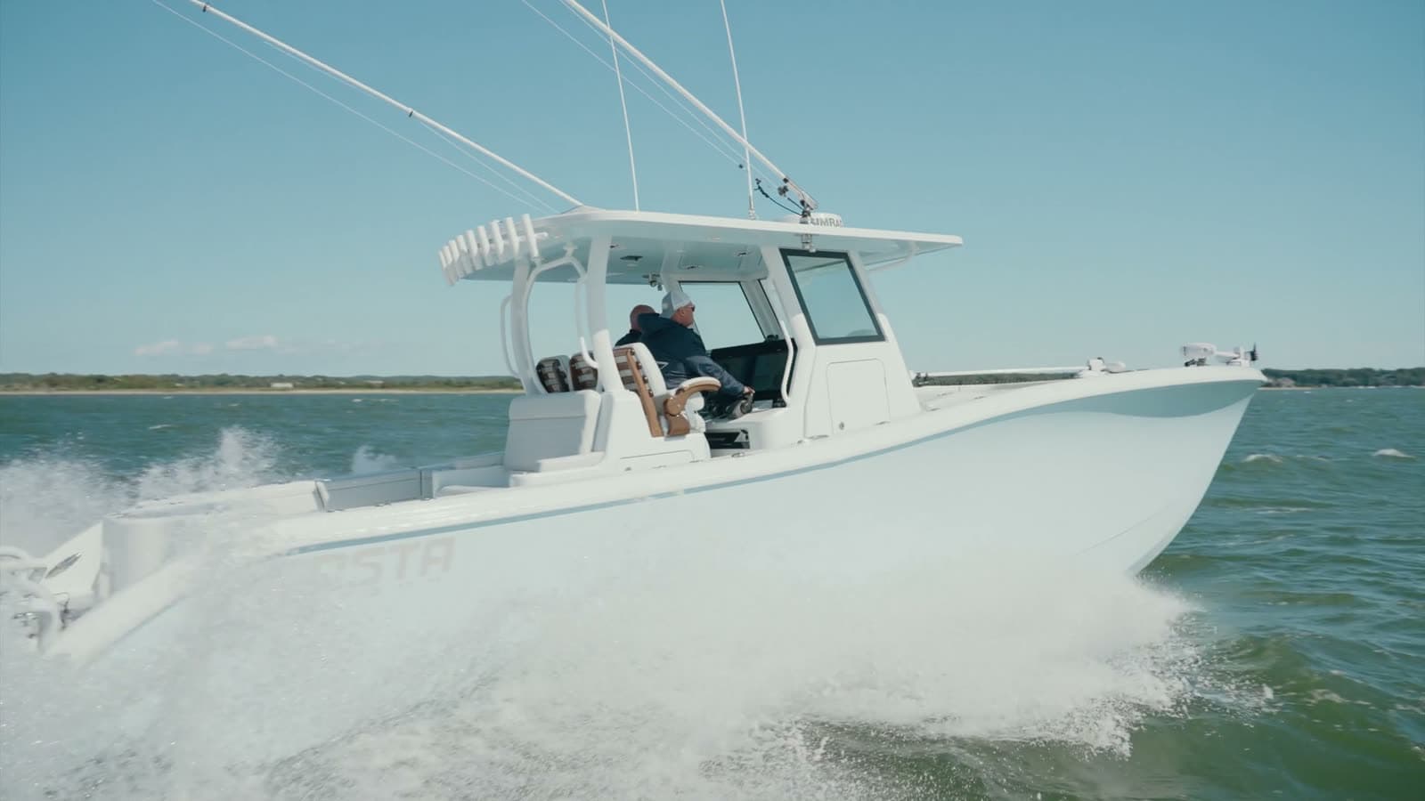 An owner at the helm of a center console under way
