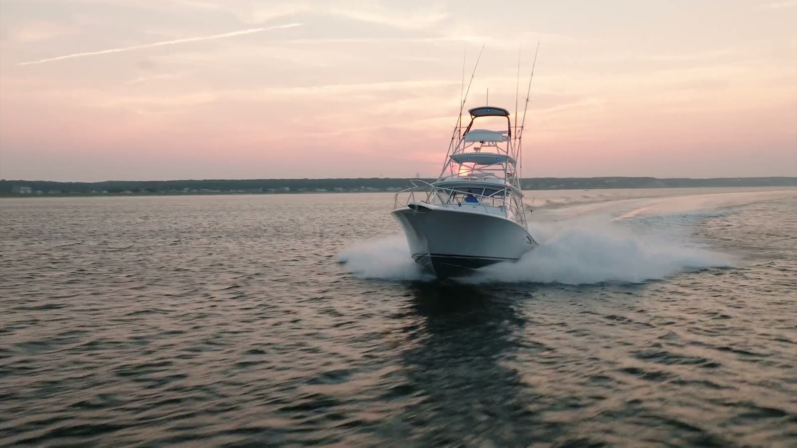 A sportfishing boat running home at dusk off the Massachusetts coast