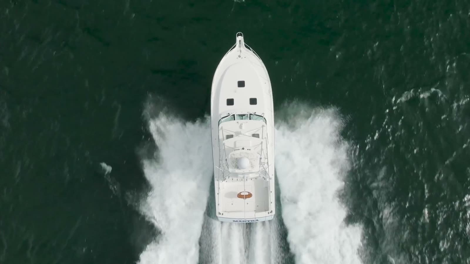 Aerial view looking down on a center console under way — the drone photography included in every listing